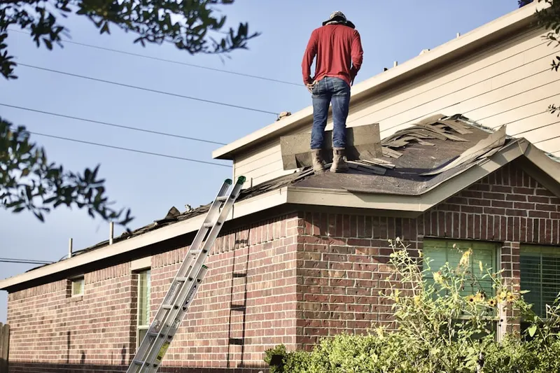 Professional roofer working on a residential roof in Downtown Bridgeport